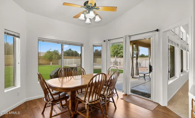 a view of a dining room with furniture wooden floor and chandelier