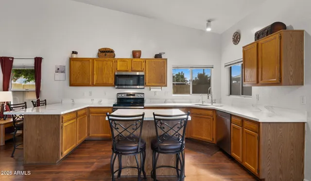 a kitchen with stainless steel appliances granite countertop a sink and a refrigerator