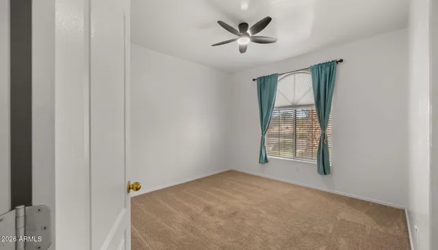 an empty room with windows and closet