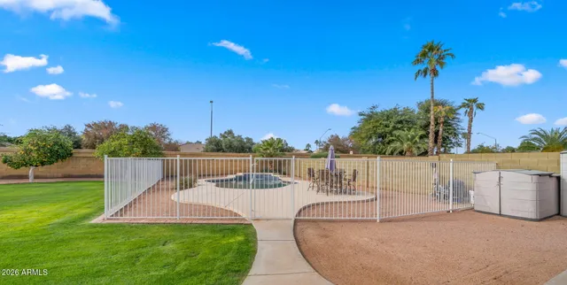 a swimming pool with outdoor seating and yard