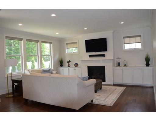 35 McCarthy Road Newton, MA 02459 - Photo 3 of 10 a living room with furniture a fireplace and a flat screen tv