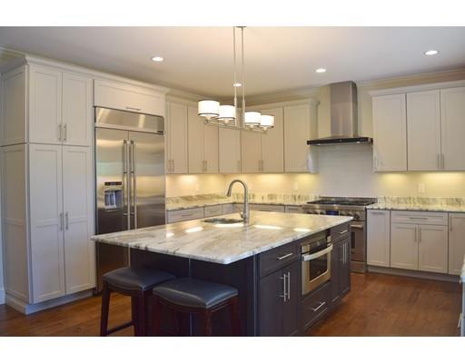 35 McCarthy Road Newton, MA 02459 - Photo 7 of 10 a kitchen with kitchen island granite countertop a sink cabinets and stainless steel appliances