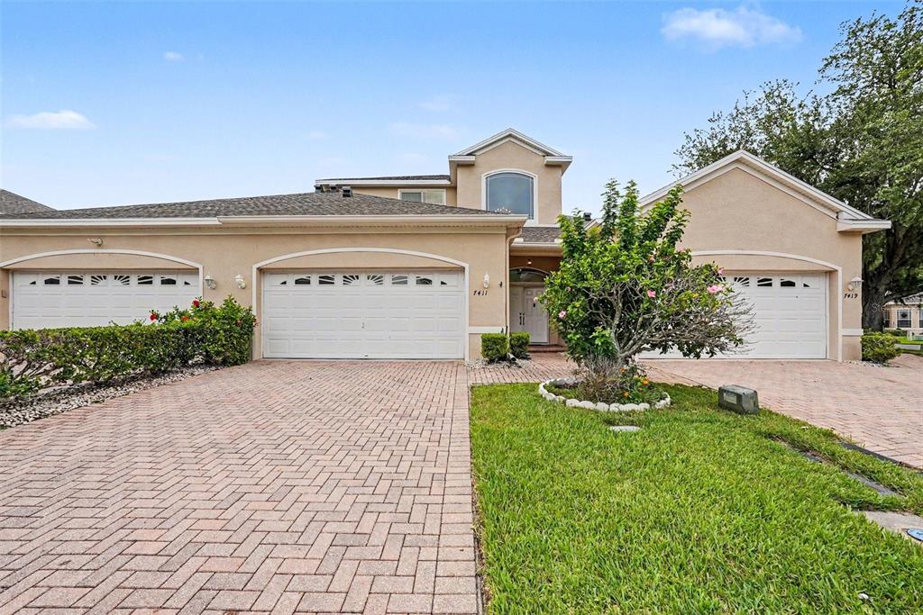 a view of a house with a yard and a garage