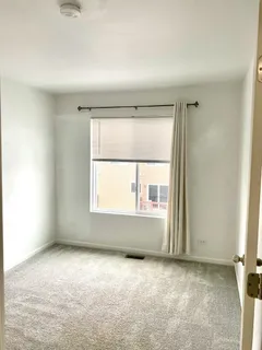 an empty room with windows and closet