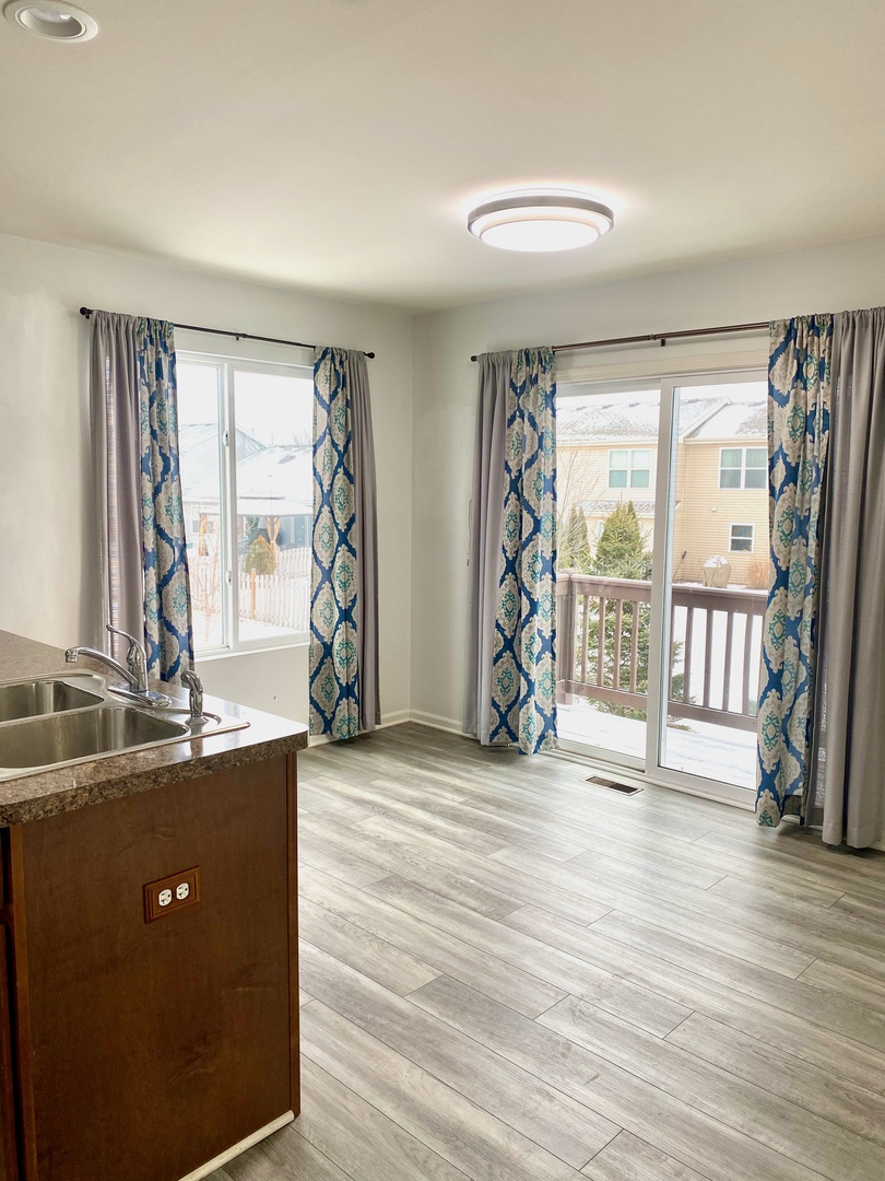 308 Niagara Drive Volo, IL 60073 - Photo 7 of 17 an empty room with wooden floor and windows