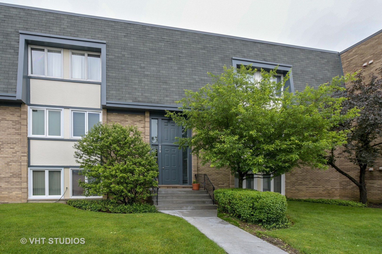1979 Ammer Ridge Court, Unit 301 Glenview, IL 60025 - Photo 1 of 12 front view of house with a yard