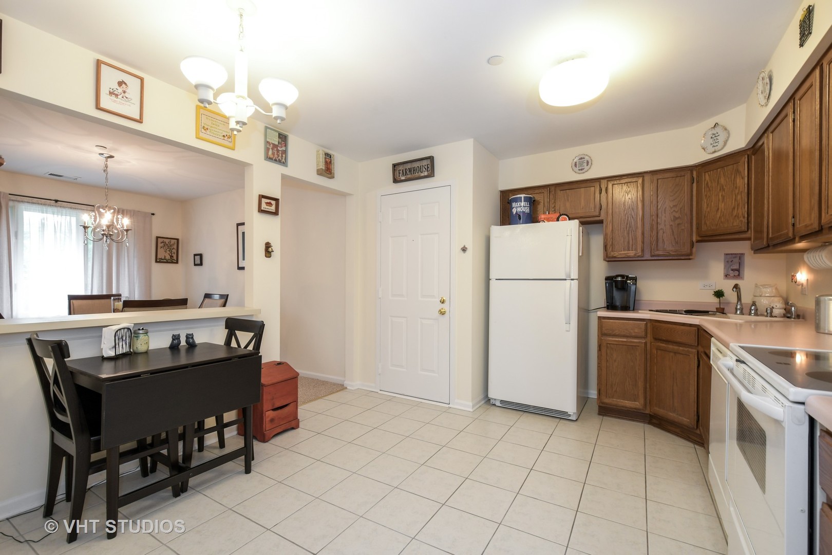 1979 Ammer Ridge Court, Unit 301 Glenview, IL 60025 - Photo 4 of 12 a kitchen with a refrigerator a stove and a dining table
