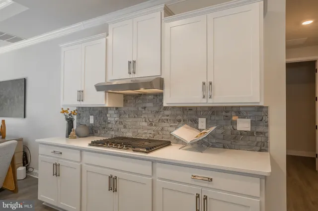 a living room with furniture and view of kitchen