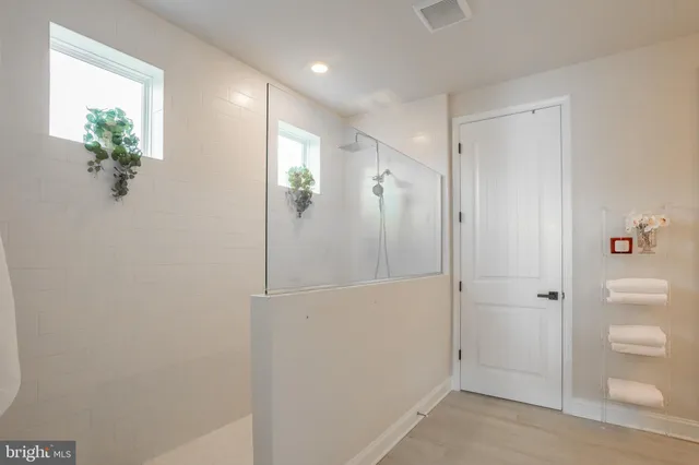 a bedroom with a bed and a potted plant