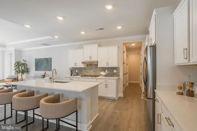 a kitchen with refrigerator cabinets dining table and chairs