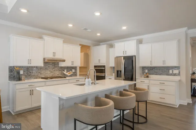 a kitchen with a sink stove and refrigerator