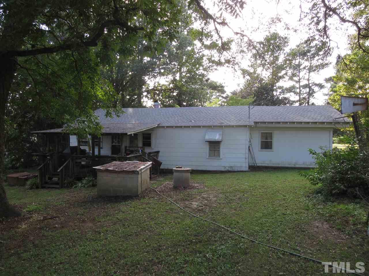 2281 Bryantown Road, Unit 68 49 ACRES Spring Hope, NC 27882 - Photo 12 of 21 a backyard of a house with table and chairs