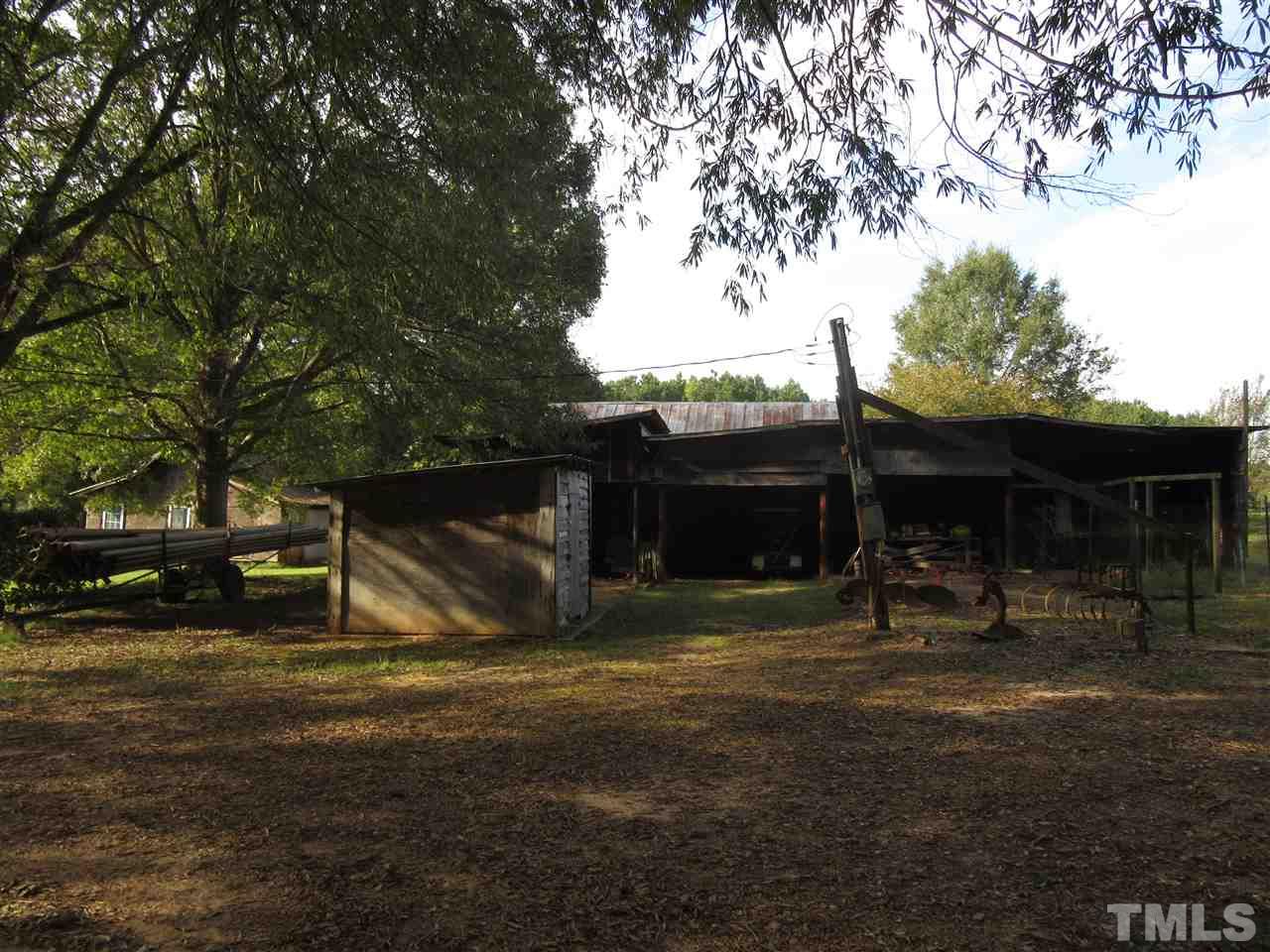 2281 Bryantown Road, Unit 68 49 ACRES Spring Hope, NC 27882 - Photo 15 of 21 a view of a backyard with table and chairs and a large tree
