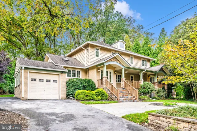 a front view of a house with a garden and plants