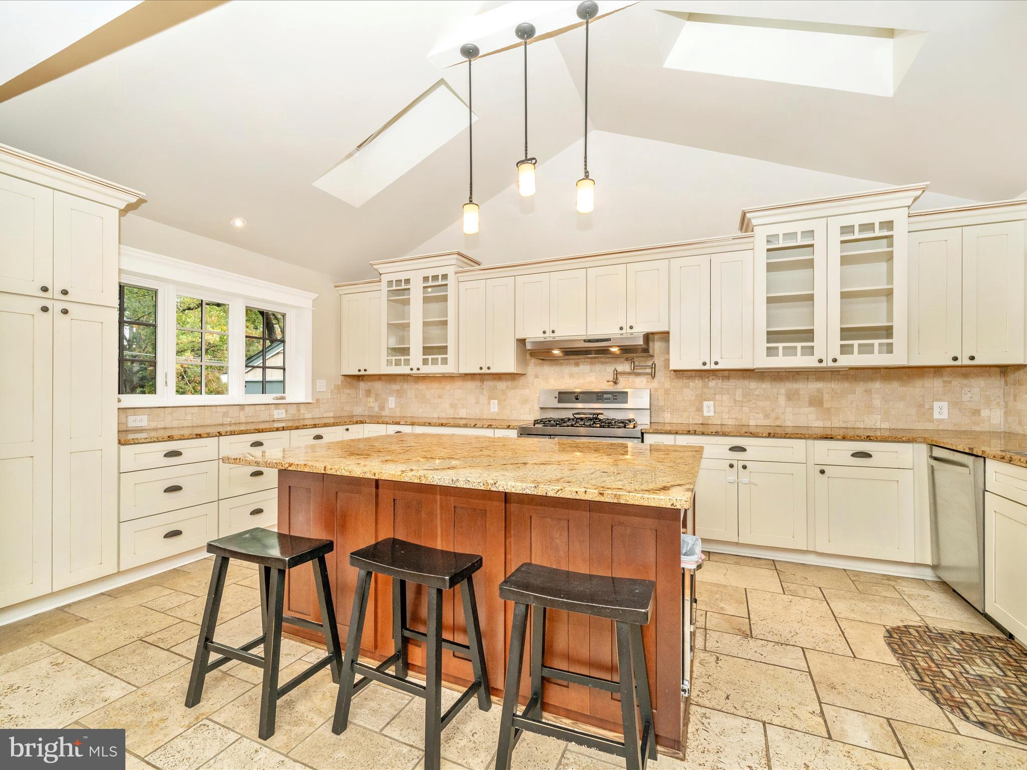 1925 Pagebrook Road Silver Spring, MD 20903 - Photo 16 of 74 a kitchen with stainless steel appliances granite countertop a stove a sink dishwasher and white cabinets with wooden floor