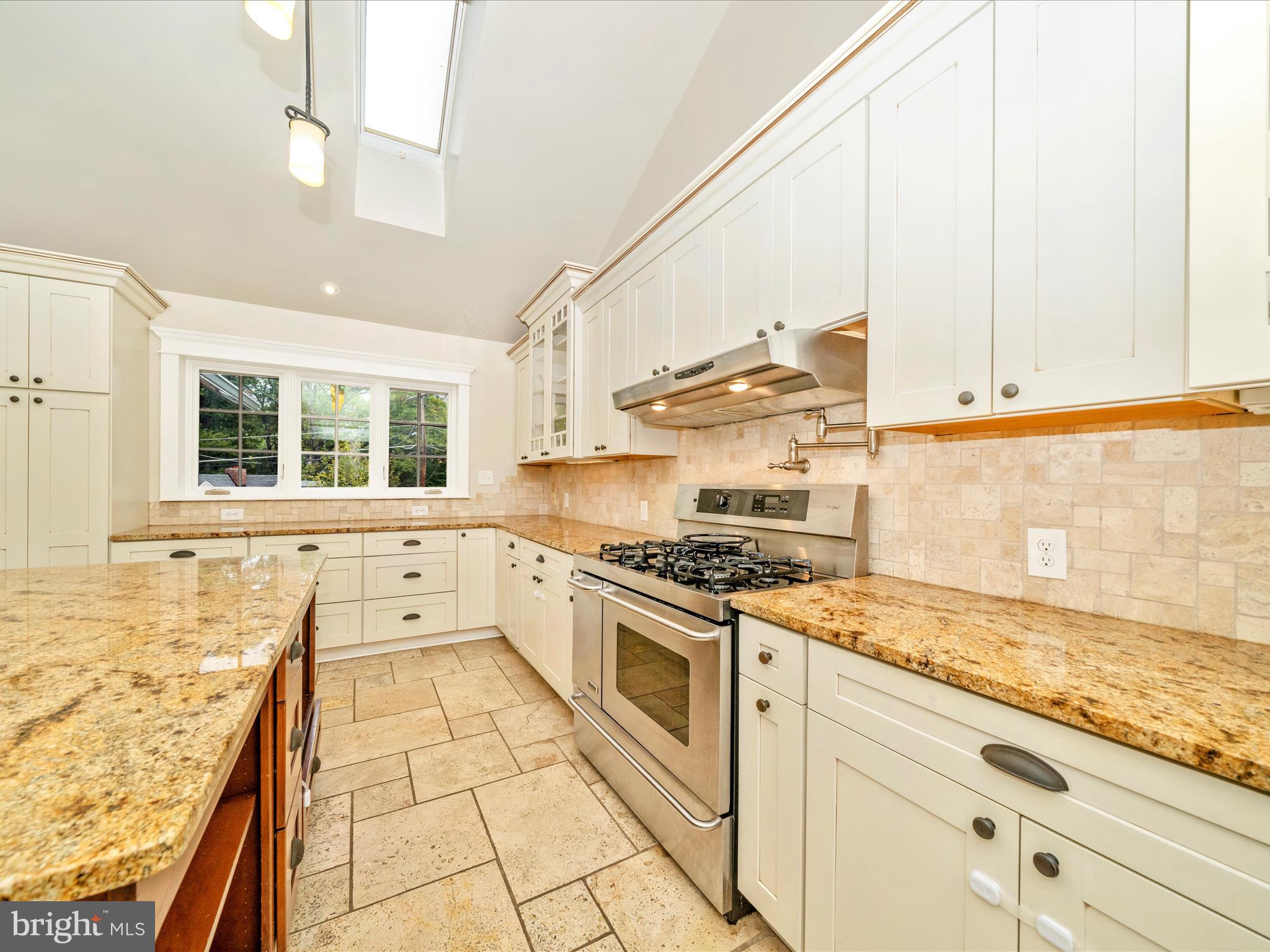 1925 Pagebrook Road Silver Spring, MD 20903 - Photo 17 of 74 a kitchen with stainless steel appliances granite countertop a stove a sink and white cabinets