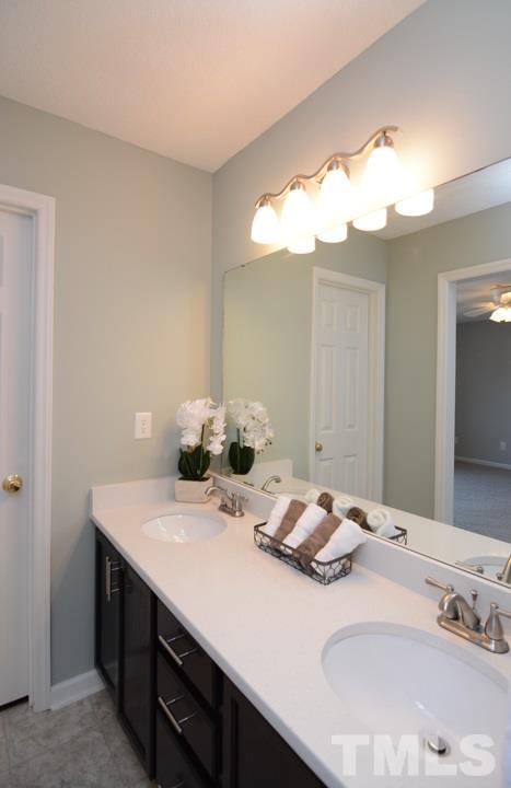 4600 Sinclair Drive Raleigh, NC 27616 - Photo 14 of 25 a bathroom with a sink and a mirror