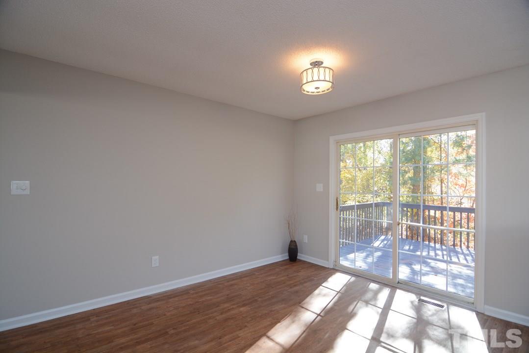 4600 Sinclair Drive Raleigh, NC 27616 - Photo 7 of 25 a view of an empty room with wooden floor and a window