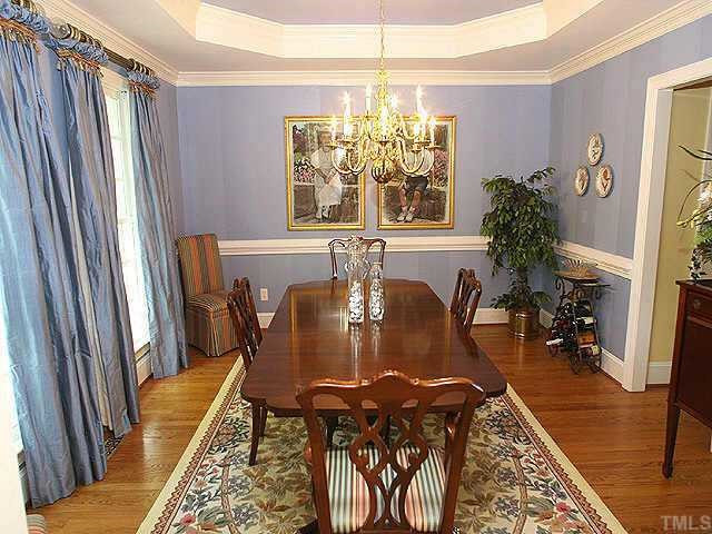 1408 Kings Branch Way Raleigh, NC 27614 - Photo 3 of 9 Invite your guests to dinner in this large dining room made for entertaining. Trey ceiling with medallion and extensive crown molding appointments are just a few of the custom details. You'll find hardwood floors throughout the first floor. Other