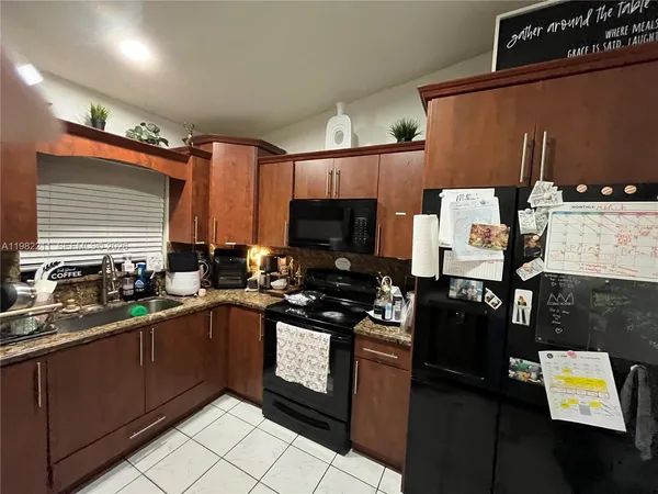 a kitchen with a sink appliances and cabinets