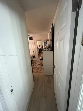 a view of a hallway with a wooden cabinets