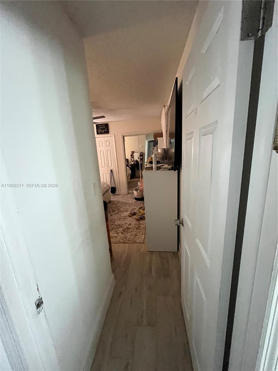 13485 Southwest 28th Street Miami, FL 33175 - Photo 13 of 33 a view of a hallway with a wooden cabinets