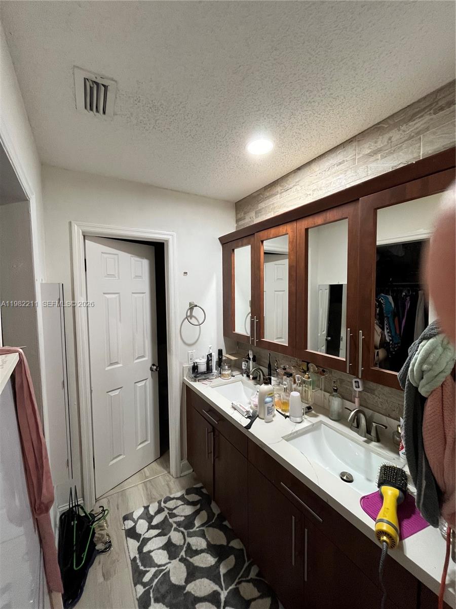 13485 Southwest 28th Street Miami, FL 33175 - Photo 15 of 33 a bathroom with double vanity and a mirror
