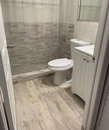 a bathroom with a toilet and a shower