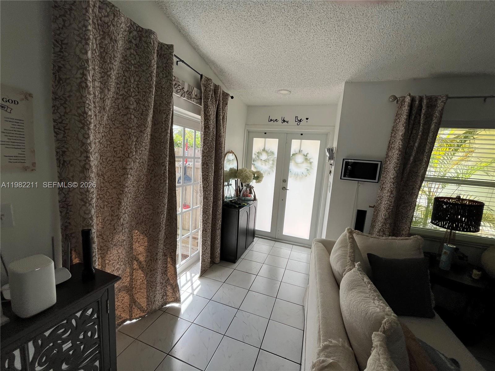 13485 Southwest 28th Street Miami, FL 33175 - Photo 2 of 33 a living room with furniture and a fireplace