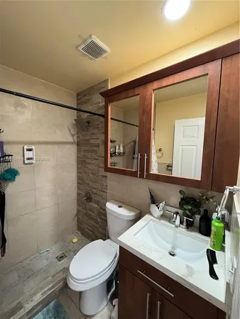 a bathroom with a sink toilet and shower
