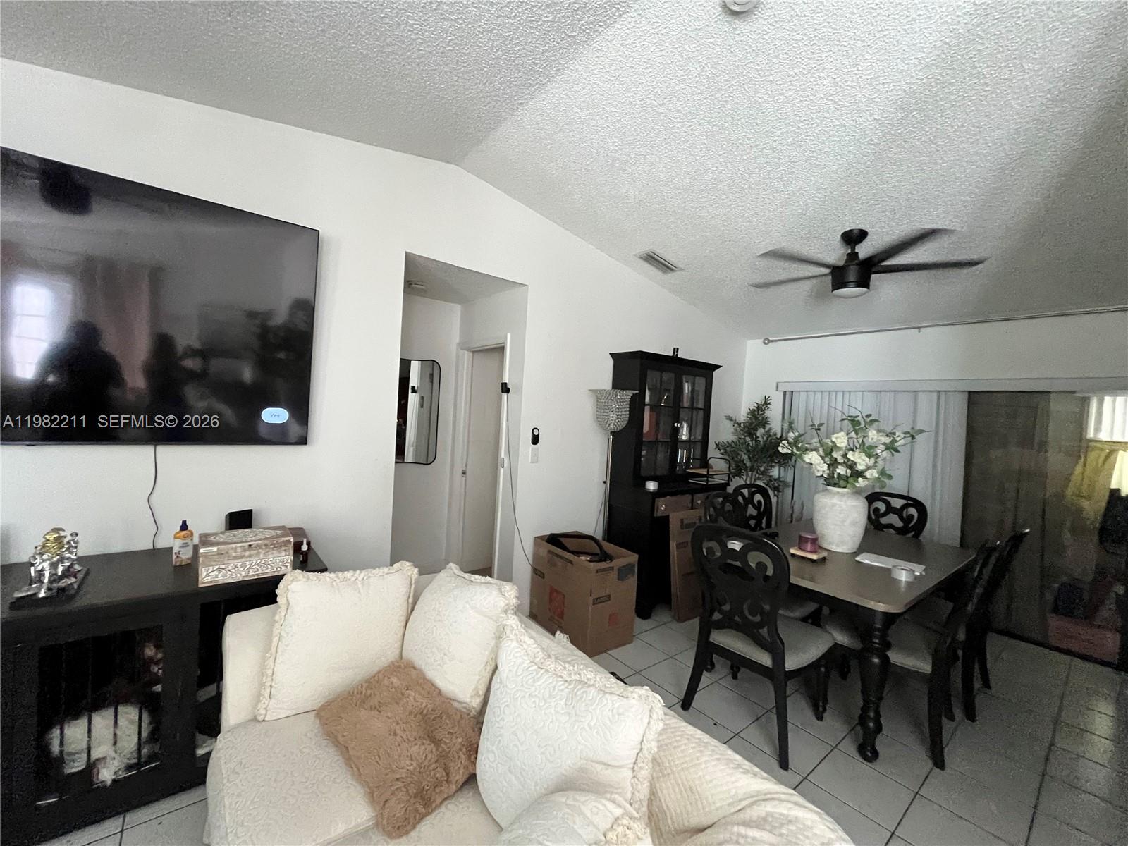 13485 Southwest 28th Street Miami, FL 33175 - Photo 5 of 33 a living room with furniture and a flat screen tv