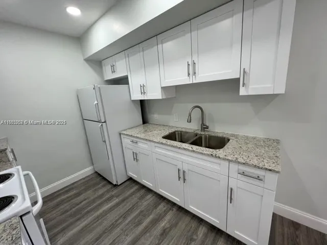 a kitchen with sink a cabinets and appliances