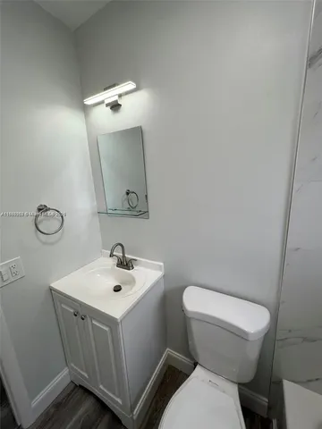 a white toilet sitting next to a bathroom sink