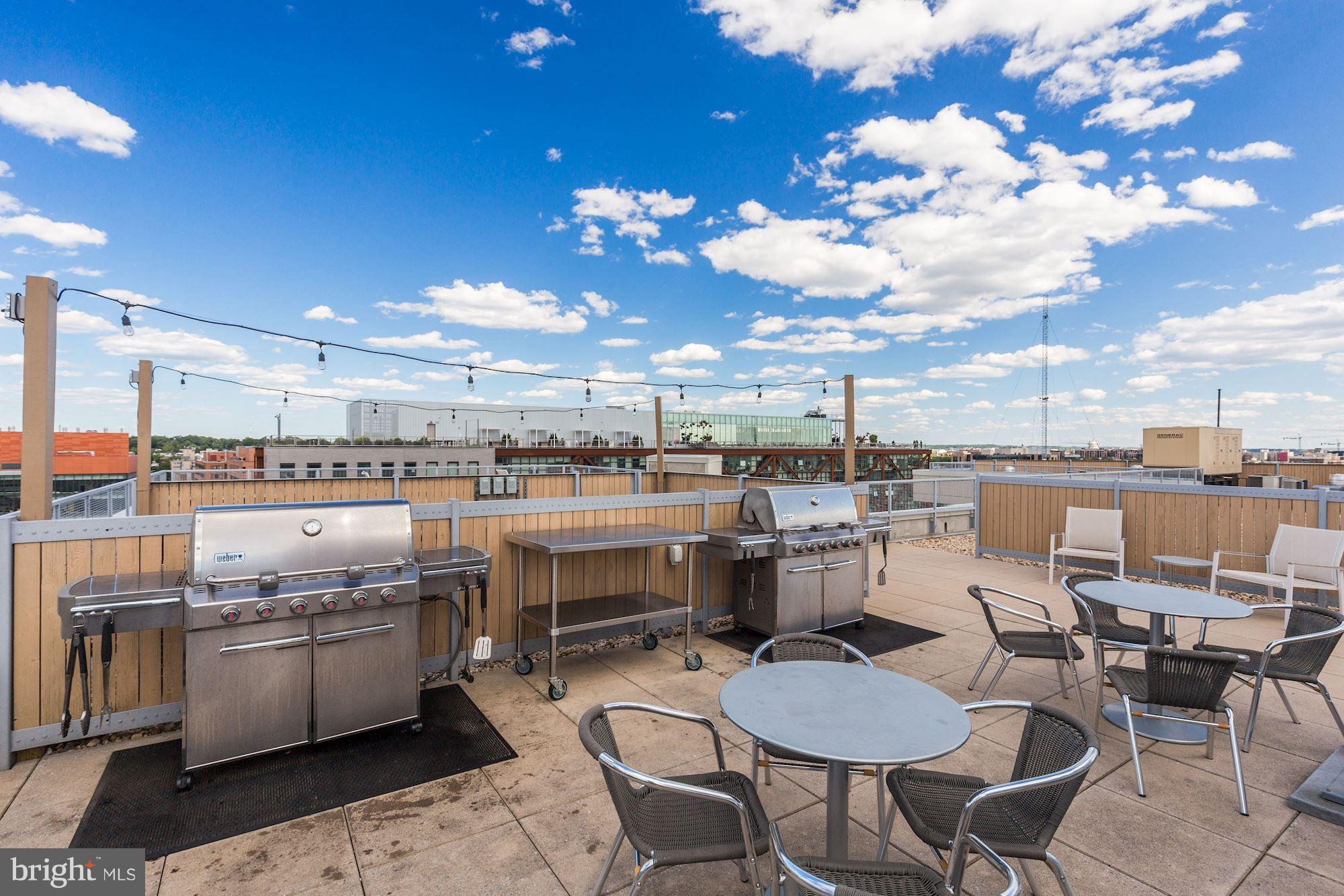 929 Florida Avenue Northwest, Unit 4002 Washington, DC 20001 - Photo 9 of 12 a kitchen with a table chairs stove and kitchen view