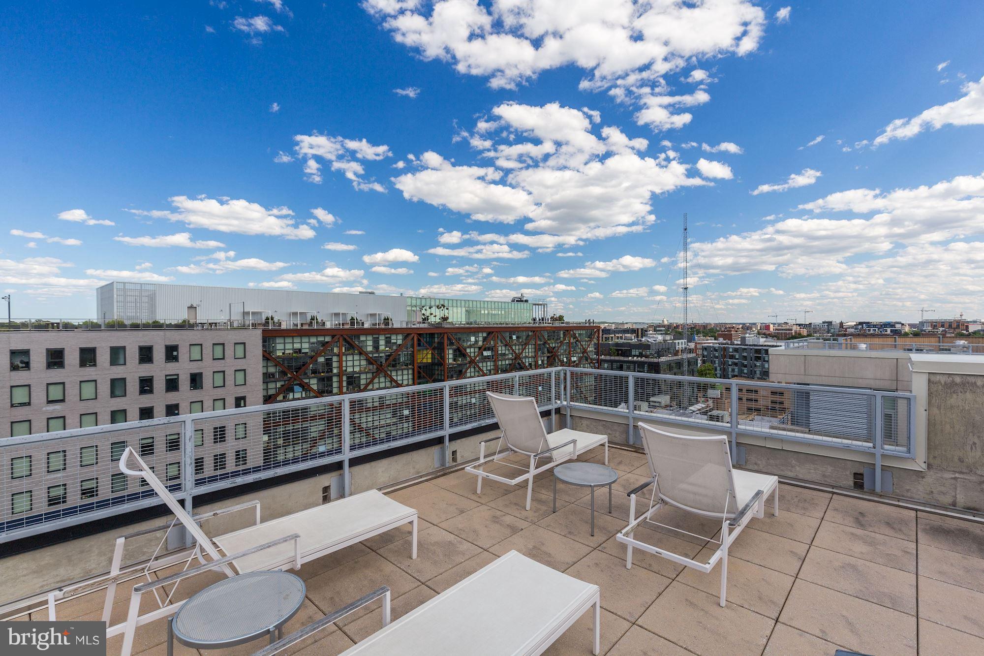 929 Florida Avenue Northwest, Unit 4002 Washington, DC 20001 - Photo 10 of 12 a view of a terrace with lawn chairs and wooden floor