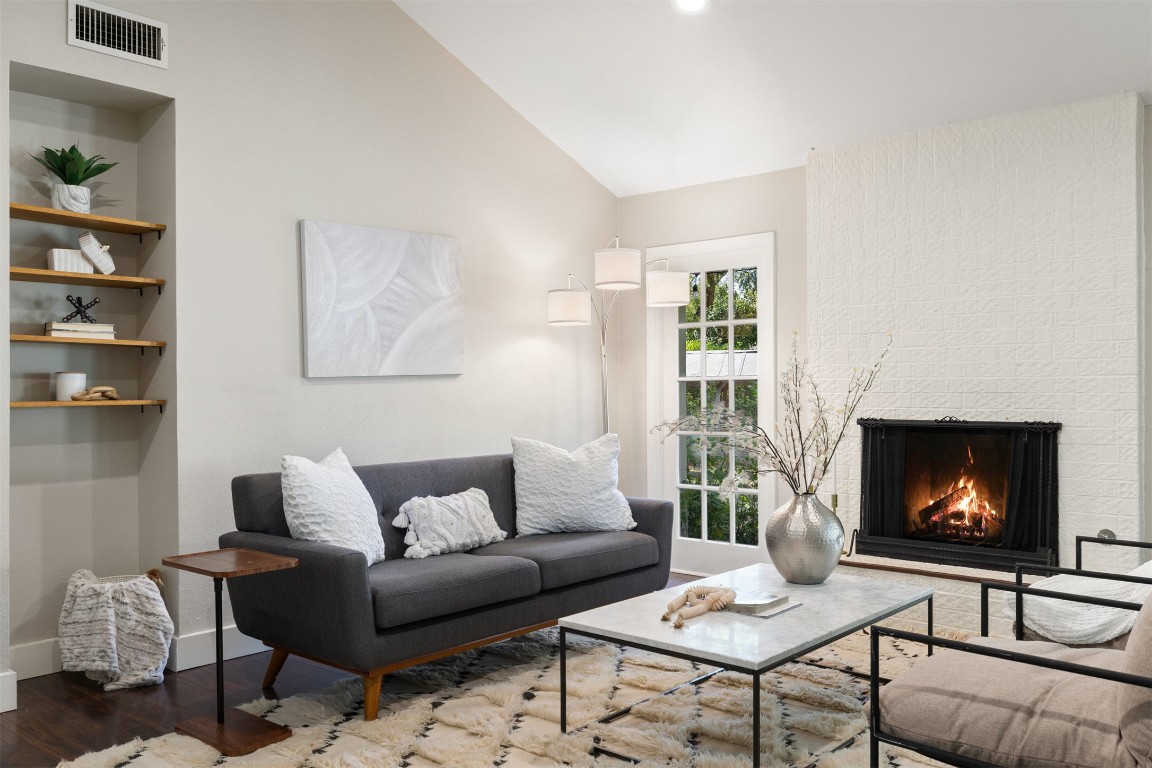 9228 Partridge Circle Austin, TX 78758 - Photo 11 of 36 a living room with furniture a flat screen tv and a fireplace