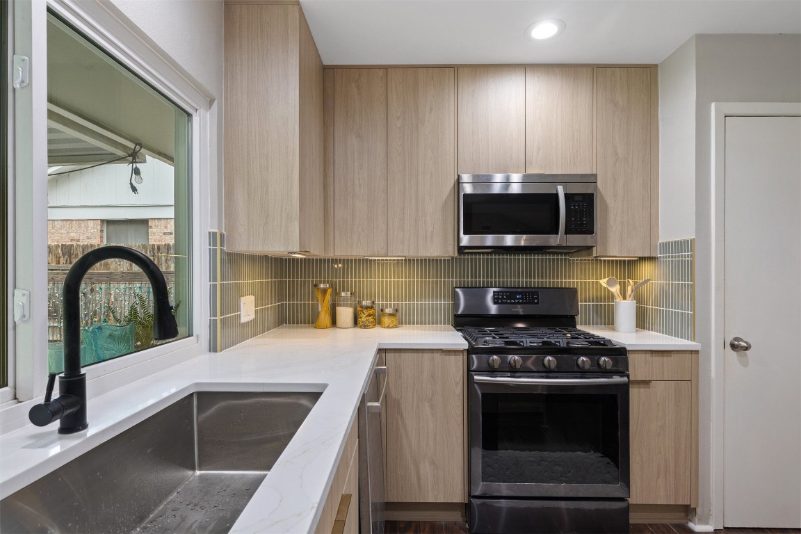 9228 Partridge Circle Austin, TX 78758 - Photo 17 of 36 a kitchen with a stove and a microwave