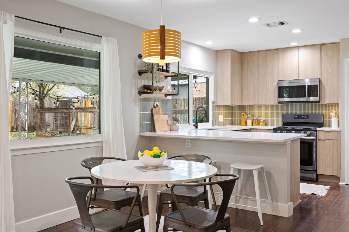 9228 Partridge Circle Austin, TX 78758 - Photo 19 of 36 a kitchen with a table chairs and microwave