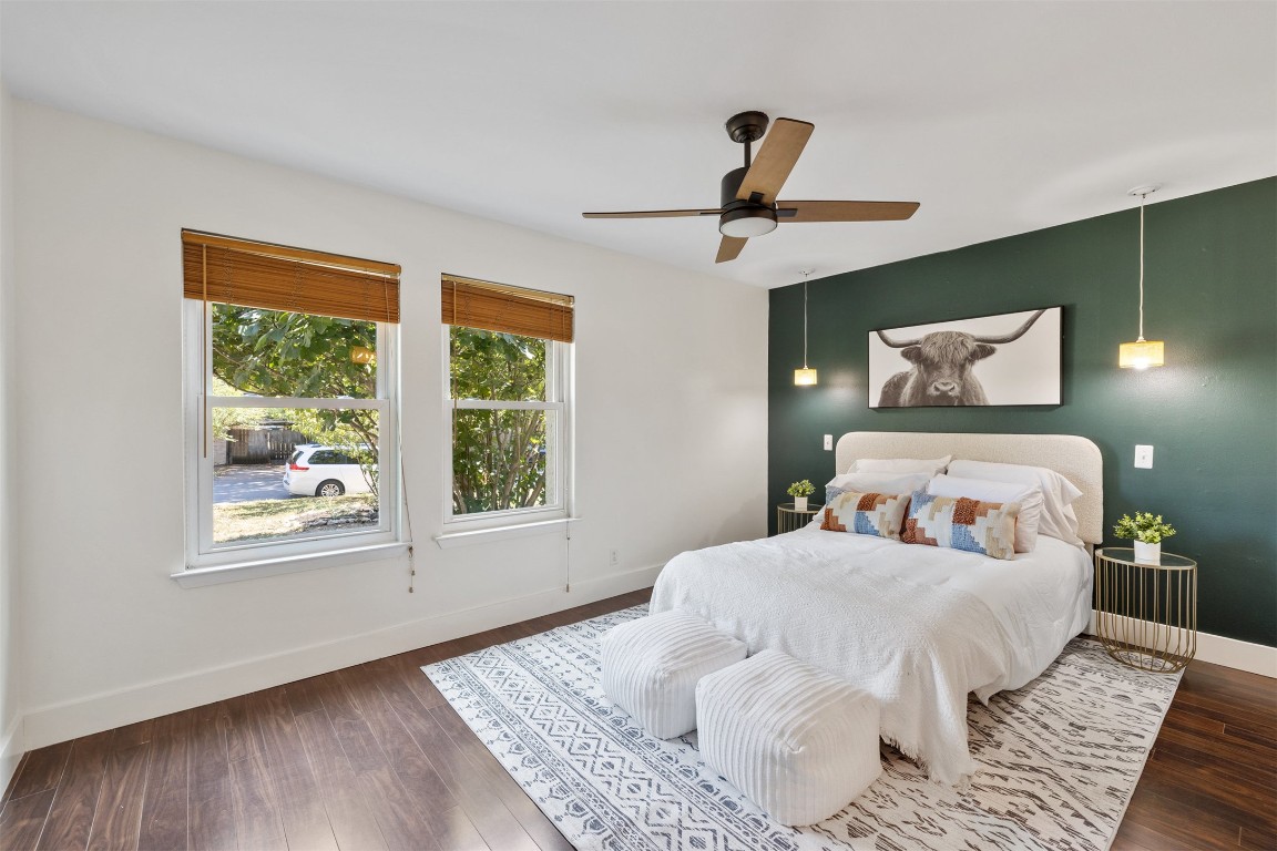 9228 Partridge Circle Austin, TX 78758 - Photo 5 of 36 a bedroom with a bed and wooden floor