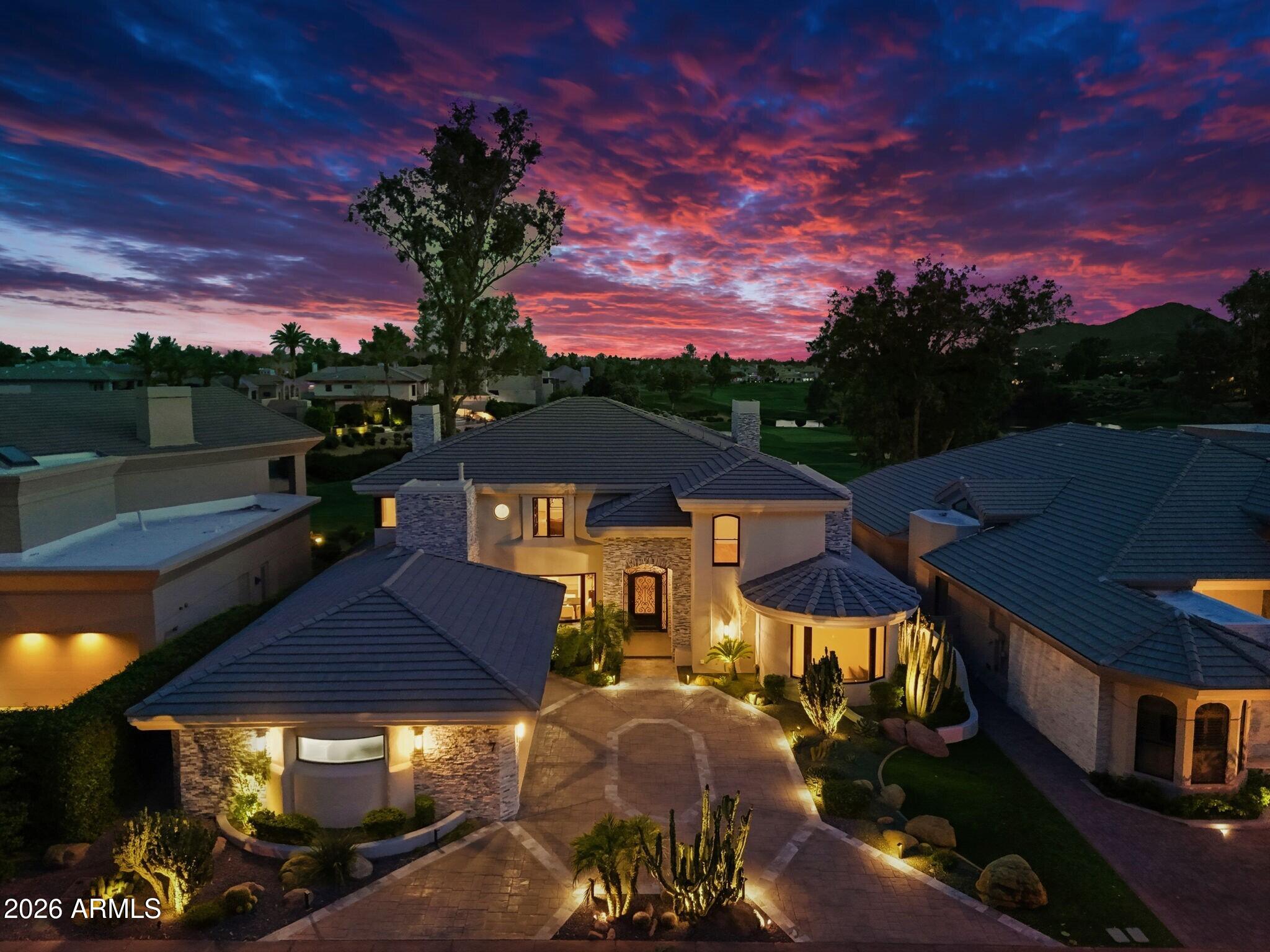 7475 East Gainey Ranch Road, Unit 7 Scottsdale, AZ 85258 - Photo 2 of 77 a front view of a house with a garden