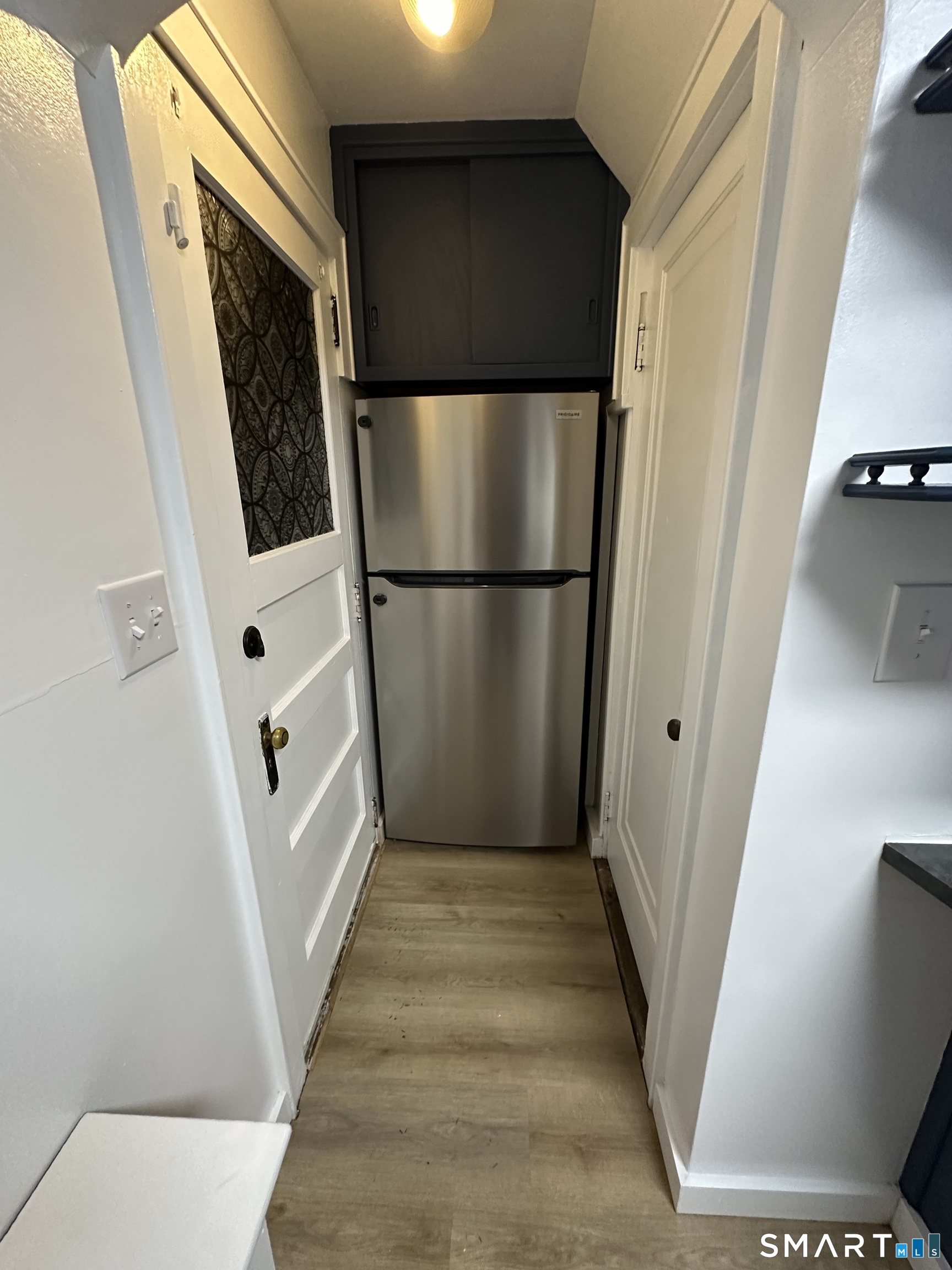 483 Charles Street Torrington, CT 06790 - Photo 11 of 40 a view of a hallway with wooden walls and staircase