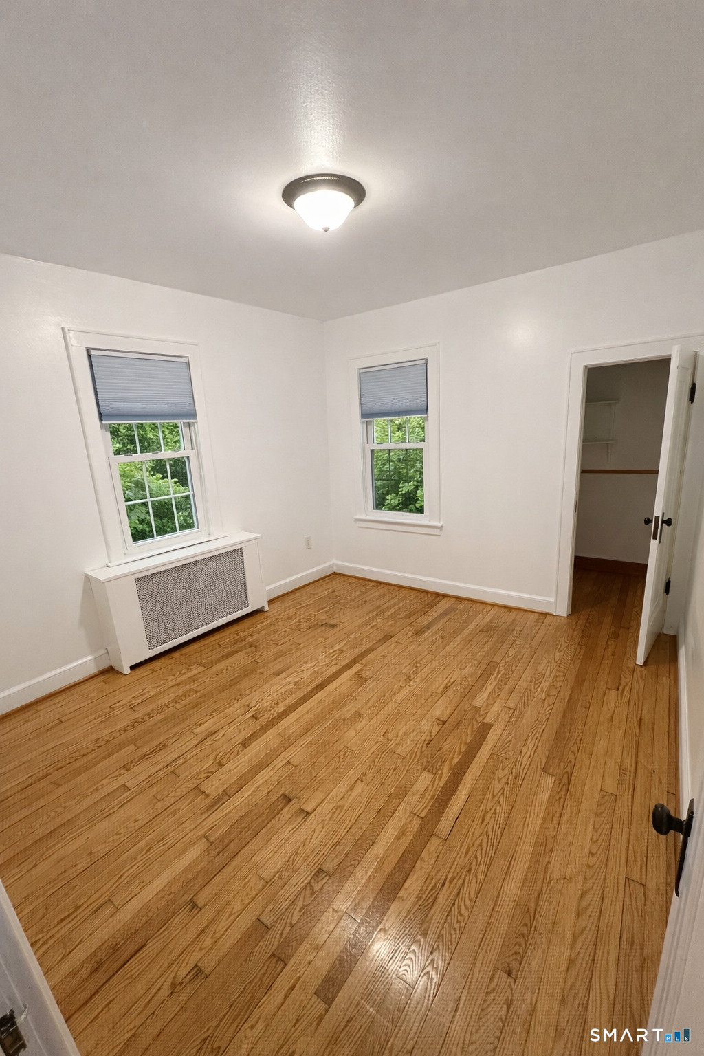 483 Charles Street Torrington, CT 06790 - Photo 13 of 40 a view of an empty room with a window and wooden floor