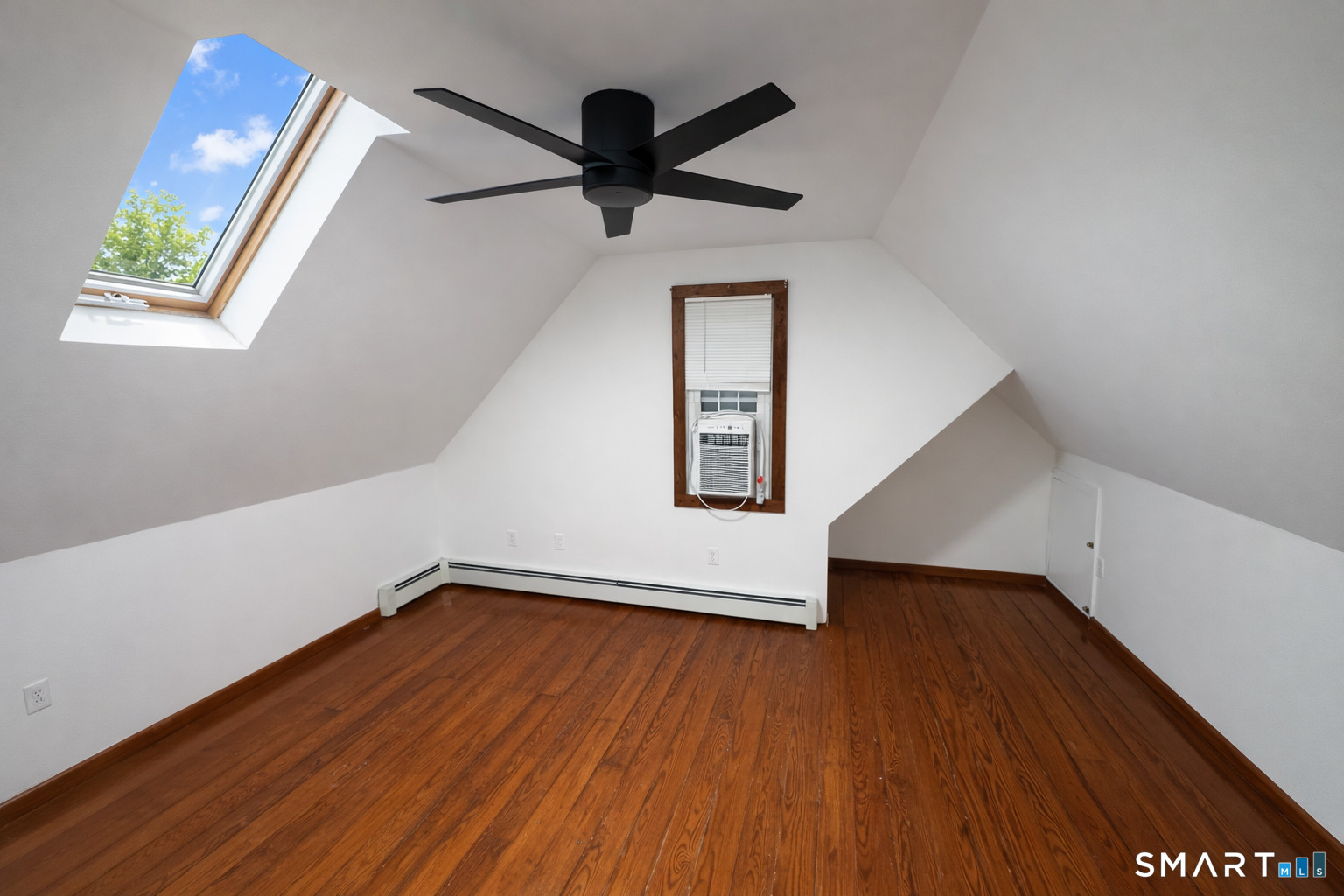 483 Charles Street Torrington, CT 06790 - Photo 19 of 40 an empty room with wooden floor fan and windows