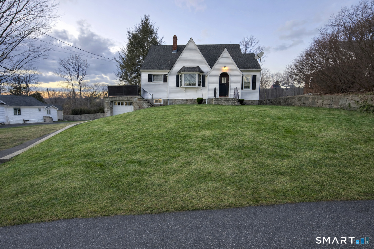 483 Charles Street Torrington, CT 06790 - Photo 2 of 40 a front view of a house with a yard and garage