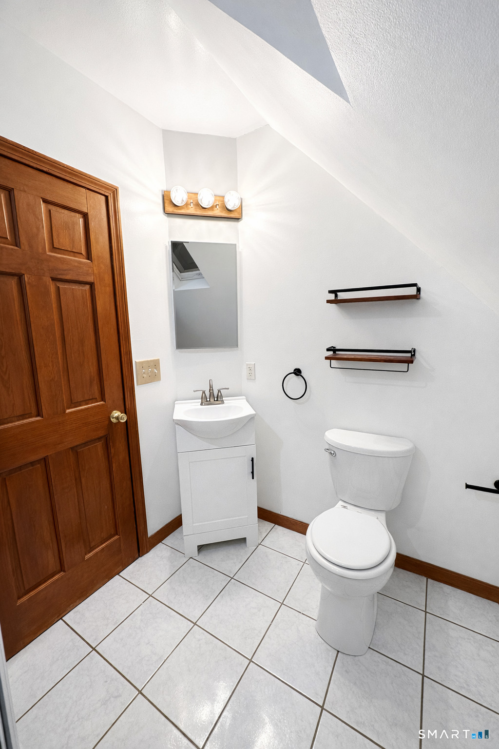 483 Charles Street Torrington, CT 06790 - Photo 21 of 40 a white toilet sitting next to a bathroom sink and a mirror