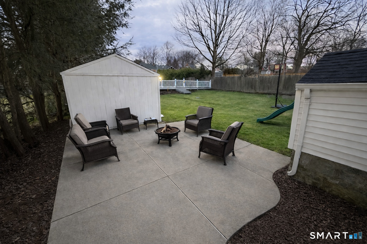 483 Charles Street Torrington, CT 06790 - Photo 32 of 40 a view of backyard with table and chairs and a fire pit