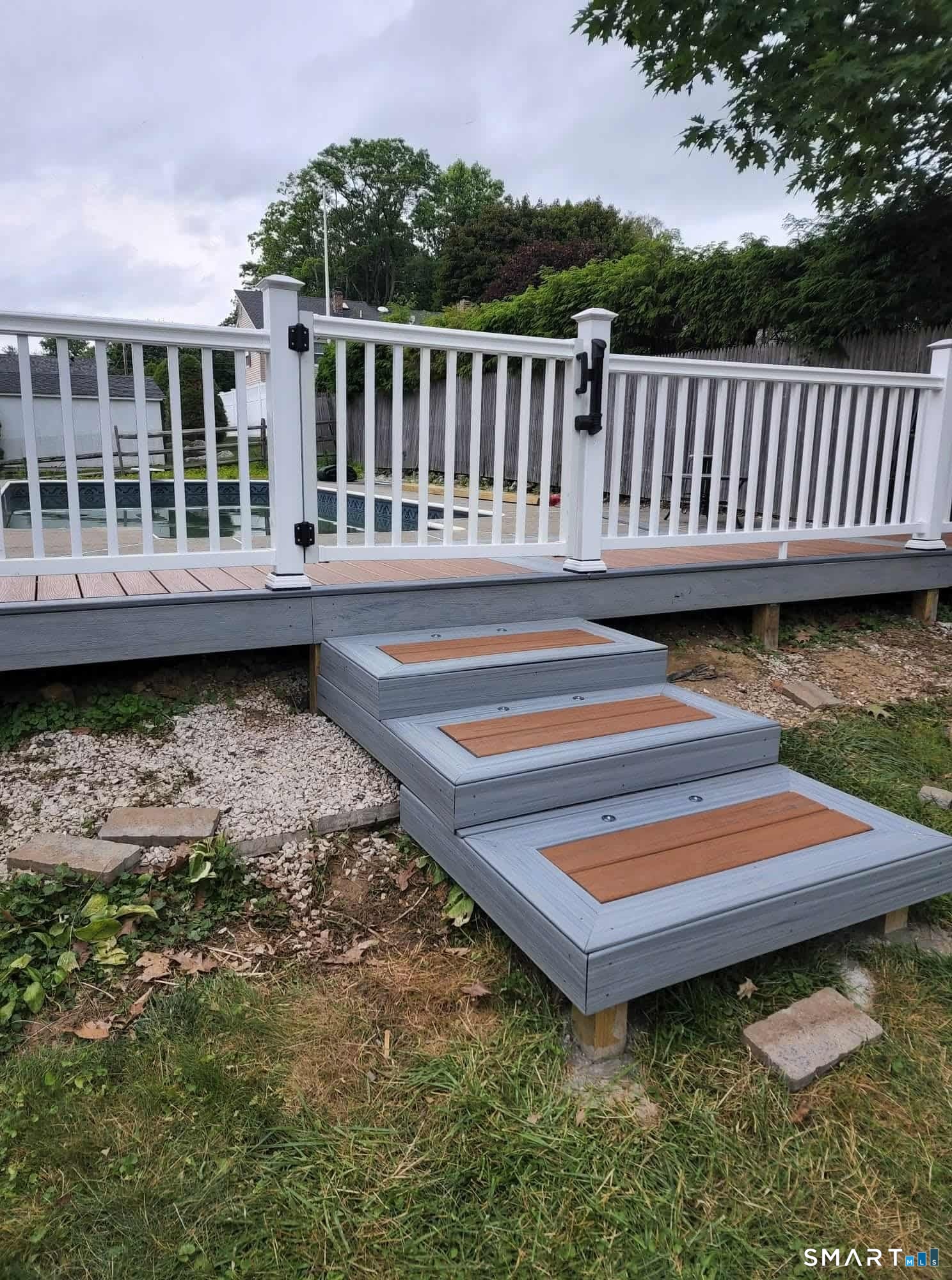 483 Charles Street Torrington, CT 06790 - Photo 37 of 40 a backyard of a house with a garden and deck