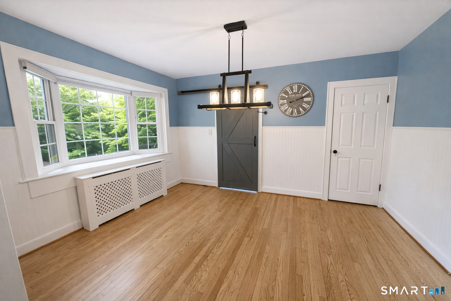 483 Charles Street Torrington, CT 06790 - Photo 7 of 40 a view of an empty room with wooden floor and a window
