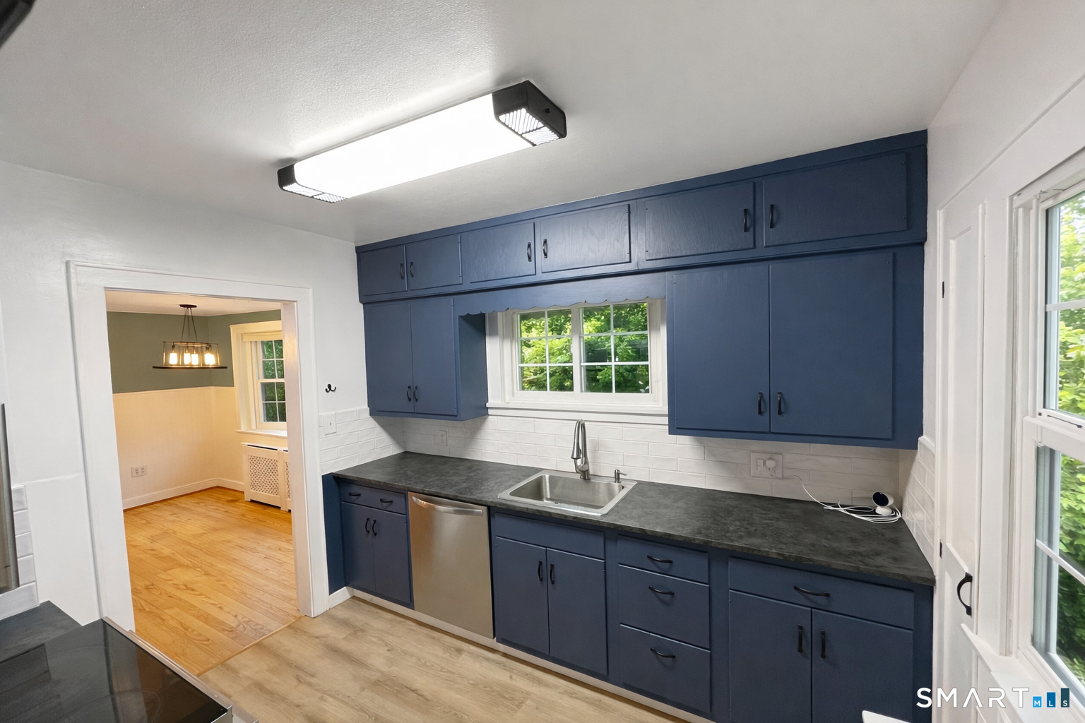 483 Charles Street Torrington, CT 06790 - Photo 10 of 40 a kitchen with granite countertop a sink and wooden cabinets