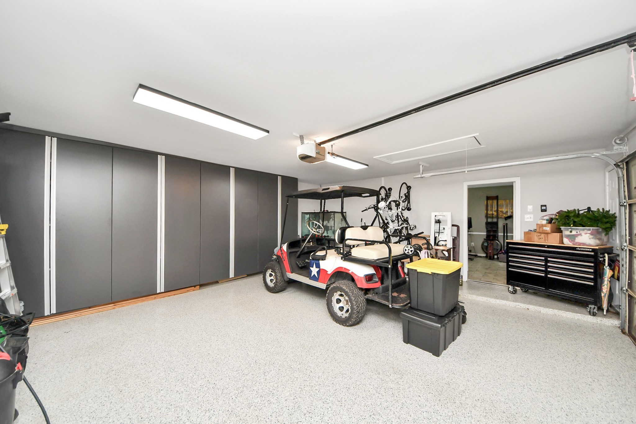 6403 Craigway Road Spring, TX 77389 - Photo 20 of 39 Spacious garage with epoxy garage floor, built-in wall storage cabinetry, and ample space for vehicles and equipment